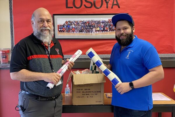 President Jesse James donating chess sets to Losoya Middle School.